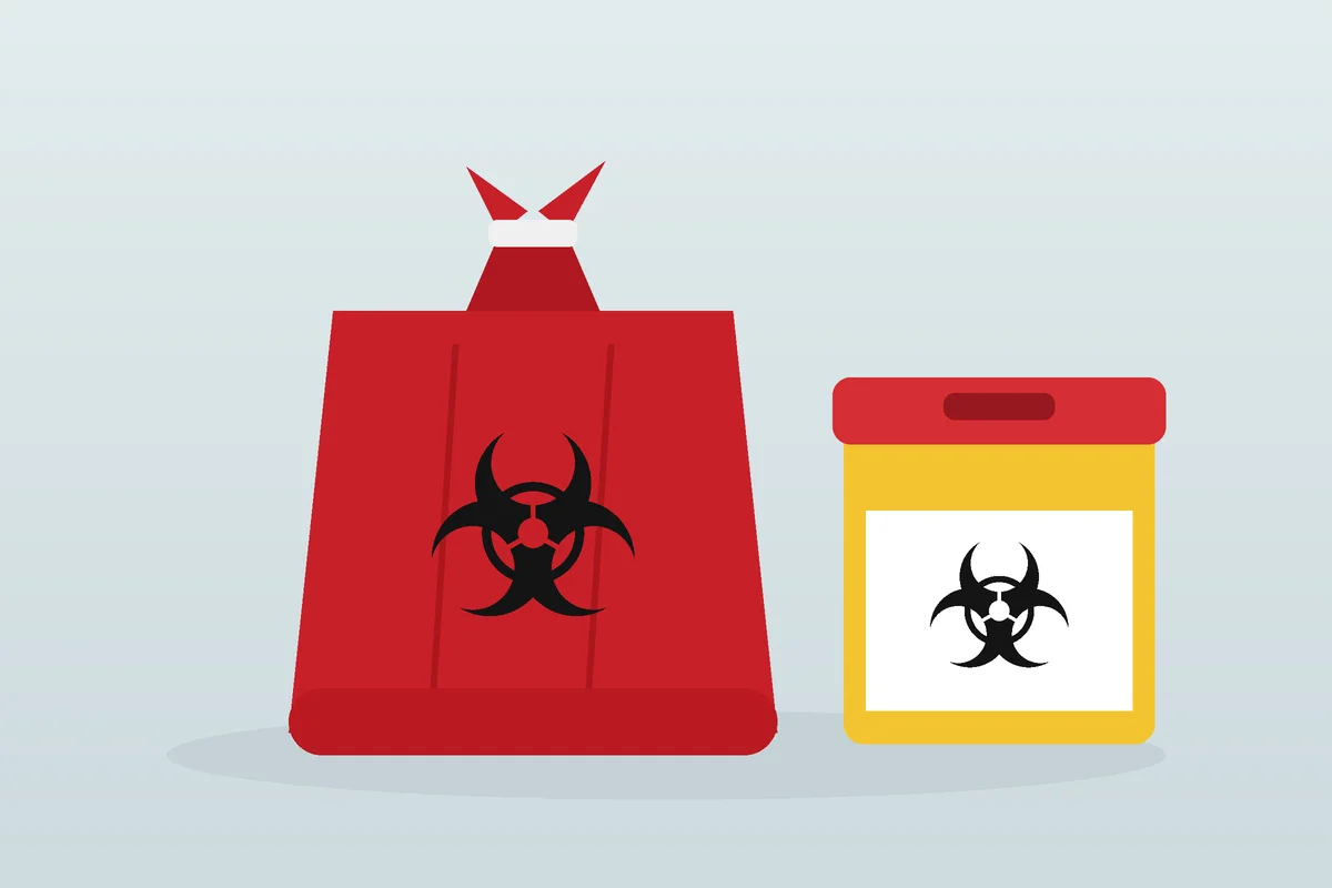 Bolsa roja y descartador para residuos patogénicos con el símbolo de riesgo biológico